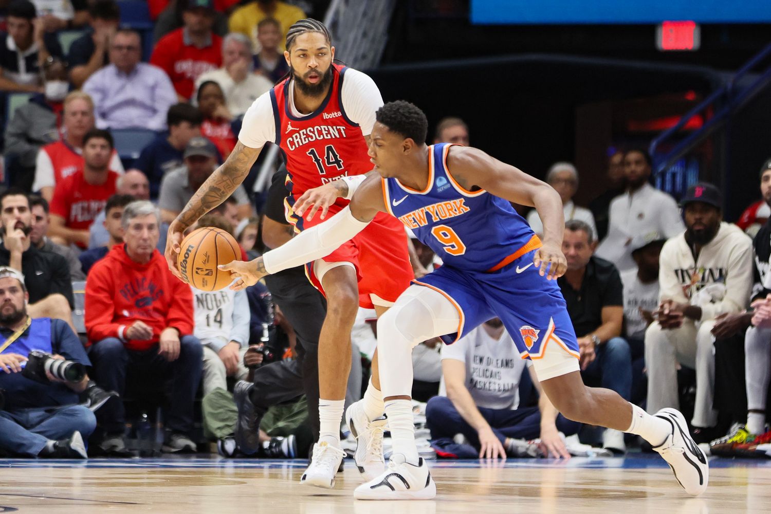 New Orleans Pelicans forward Brandon Ingram (14) is pressured by New York Knicks guard RJ Barrett (9) in the fourth quarter at Smoothie King Center.